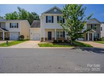 Charming two-story home with black shutters, attached garage, and a well-maintained lawn at 8226 Gabon Ct, Charlotte, NC 28215