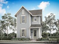 Charming two-story home featuring light blue siding, complemented by grey shutters and a well-maintained lawn at 9117 Maybry Park St # Lot 117, Charlotte, NC 28212