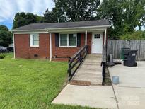 Charming brick home featuring a ramp to the front door and a well-maintained lawn at 9401 Old Moores Chapel Rd, Charlotte, NC 28214
