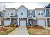 Charming townhome showcasing brick and siding exteriors, garages, and well-maintained landscaping at 1028 Grays Mill Rd, Charlotte, NC 28215