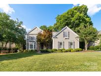 Charming two-story home featuring a beautifully landscaped front yard and a welcoming facade at 10927 Thornhill Club Dr, Charlotte, NC 28277