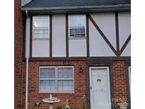 Charming Tudor-style home with brick facade, decorative trim, and a well-maintained front yard at 1300 Larchmont Pl, Salisbury, NC 28144