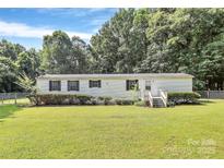 Charming single-story home featuring a well-manicured lawn, classic white siding, and dark shutters at 1310 Glasscock Rd, Rock Hill, SC 29730