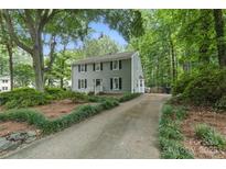 Charming two-story home with gray siding, black shutters, and a well-manicured front yard at 1517 E Barden Rd, Charlotte, NC 28226