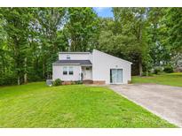 Charming home showcasing a modern design with a well-maintained lawn and a long driveway at 221 Reliance Rd, Kings Mountain, NC 28086