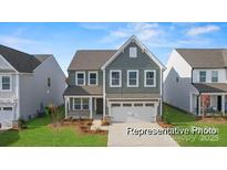 Charming two-story home featuring a gray exterior, well-manicured lawn, and a two-car garage at 32612-B Millingport Rd # 7157, New London, NC 28127
