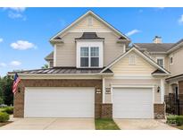 Charming townhome featuring a two-car garage and a classic facade with brick and siding accents at 44409 Oriole Dr # 200, Indian Land, SC 29707