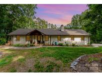 Charming single-story home with a brick facade, beautiful landscaping, and a cozy front entrance at 524 Heritage Vw, Indian Trail, NC 28079