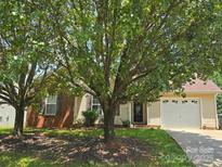 Charming home featuring a well maintained lawn, brick accents and inviting curb appeal at 6902 Vernon Wood Ln, Charlotte, NC 28262