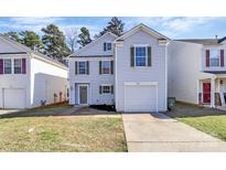 Charming two-story home featuring light siding, green shutters, a one car garage, and a well-manicured front lawn at 7214 Fox Point Dr, Charlotte, NC 28269