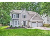 Charming two-story home featuring a two-car garage and well-manicured lawn at 7810 Leisure Ln, Huntersville, NC 28078