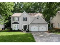 Charming two-story home featuring a well-manicured lawn and a spacious three-car garage at 7810 Leisure Ln, Huntersville, NC 28078
