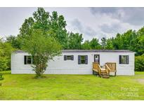 Charming single-story home with white siding, black shutters, front yard, and a wooden porch and stairs at 976 Neely Store Rd, Rock Hill, SC 29730