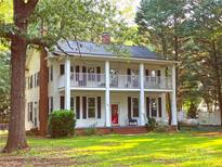 Charming two-story home with a double-decker porch and a red front door at 1282 W Hwy 27 Hwy, Lincolnton, NC 28092