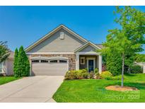 Charming single-story home featuring a stone-accented facade, two-car garage, and well-manicured lawn at 1313 Haywood Park Rd, Marvin, NC 28173