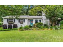 Charming cottage-style home with brick facade, colorful landscaping, and inviting front yard at 151 Cynthia St, Statesville, NC 28677