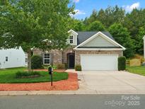 Charming brick home with well-manicured landscaping, attached two-car garage, and inviting curb appeal at 1660 Beleek Ridge Ln, Lake Wylie, SC 29710