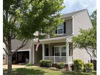 Charming two-story home with a covered porch, well-maintained lawn, and an attached two-car garage at 1673 Beleek Ridge Ln, Clover, SC 29710