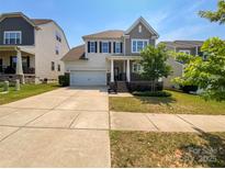 Charming two-story home with a well-maintained lawn and attached two-car garage at 1680 Trentwood Dr, Fort Mill, SC 29715