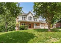 Charming two-story home with a brick and siding exterior, a manicured lawn, and a covered front porch at 176 Sharon Valley Dr, Hickory, NC 28601