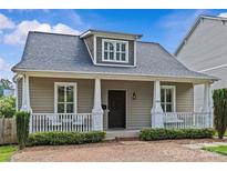 Charming front exterior of a home with inviting porch, brick pathway, and well-maintained landscaping at 1826 Hall Ave, Charlotte, NC 28205