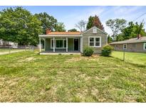 Charming single-story home featuring a covered front porch and well-maintained lawn at 2136 W 6Th Ave, Gastonia, NC 28052
