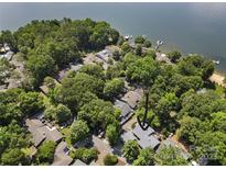 A lovely waterfront house is nestled among trees with its own dock and easy access to the open water at 26 New River Trce, Lake Wylie, SC 29710
