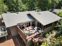 An aerial view of the back of the home highlighting the outdoor deck with plush seating at 26 New River Trce, Lake Wylie, SC 29710