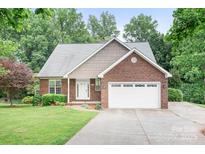 Charming brick home featuring an attached two-car garage and well-manicured lawn at 2695 Queens Rd, Lincolnton, NC 28092
