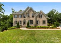 Beautiful two-story brick home featuring manicured landscaping, shutters, and a well-maintained lawn at 2857 Scarborough Ct, Gastonia, NC 28054