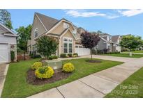 Beautiful two-story home with a well-manicured lawn and lovely landscaping at 3008 Laney Pond Rd, Matthews, NC 28104