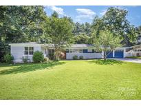 Charming single-story home with a large front yard and mature trees at 409 Edgewood Ct, Lancaster, SC 29720