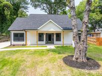 Charming home with a welcoming front porch, fresh green lawn, and lovely curb appeal at 520 E Main St, Dallas, NC 28034