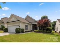 Charming single-story home featuring a two-car garage and a well-manicured lawn and garden at 56119 Finches Ct, Indian Land, SC 29707