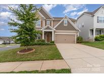 Charming two-story home with a well-manicured lawn, a two-car garage, and mature landscaping at 732 Altamonte Dr, Clover, SC 29710