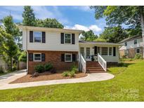 Charming two-story home with brick and white siding, black shutters, and inviting front yard at 1013 Eaglewood Ave, Charlotte, NC 28212