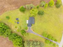 A birds eye view of a home surrounded by a lush green lawn and bordered by mature trees at 1162 E Doc Garris Rd, Lancaster, SC 29720