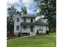 Charming two-story home features a welcoming front porch and meticulously landscaped front yard at 1256 Canseco Ln, Hickory, NC 28602