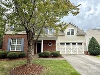 Charming two-story home with brick and siding exterior, featuring a two-car garage and well-maintained landscaping at 1304 Ridge Haven Rd, Waxhaw, NC 28173