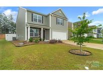 Two-story home with gray siding, stone accents, and a well-manicured lawn showcasing its curb appeal at 1323 Mifflin Ln, Dallas, NC 28034