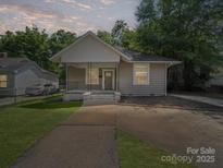 Charming home with a well-manicured lawn and inviting front porch at 144 Walnut St, Chester, SC 29706