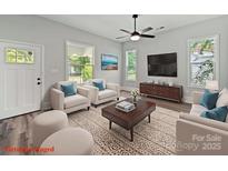 Bright living room featuring stylish furniture, modern entertainment center, and sunlit windows at 144 Walnut St, Chester, SC 29706