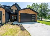 Modern two-story home with black garage door, natural wood accents and manicured lawn at 1520 Enochville Rd, Kannapolis, NC 28081