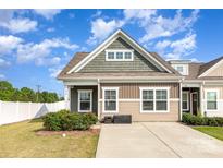 Charming exterior view of a two-story home with a well-manicured lawn and a paved driveway on a sunny day at 218 Canina Ln, Indian Trail, NC 28079