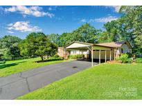 Charming single-story home with a spacious carport and well-maintained landscaping at 2326 Horseshoe Bend Ne Rd, Hickory, NC 28601