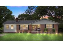 Charming brick home with manicured lawn, featuring updated lighting and inviting front porch at 2536 Cambridge Dr, Lancaster, SC 29720