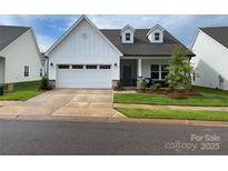 Charming, traditional home with a well-manicured lawn, dormer windows and a large attached garage at 25952 Appleyard Ct, Lancaster, SC 29720