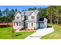 Charming two-story home with manicured lawn and a welcoming covered porch at 277 Triple Ponds Ct, Clover, SC 29710