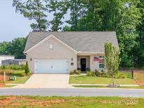 Charming brick home with a well-manicured lawn, an attached two-car garage, and an inviting front porch at 3006 Constitution Ln, Gastonia, NC 28056