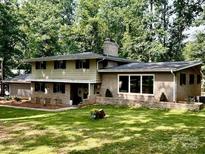 Charming two-story home with a brick facade and lush green lawn at 411 Saint Andrews Rd, Statesville, NC 28625